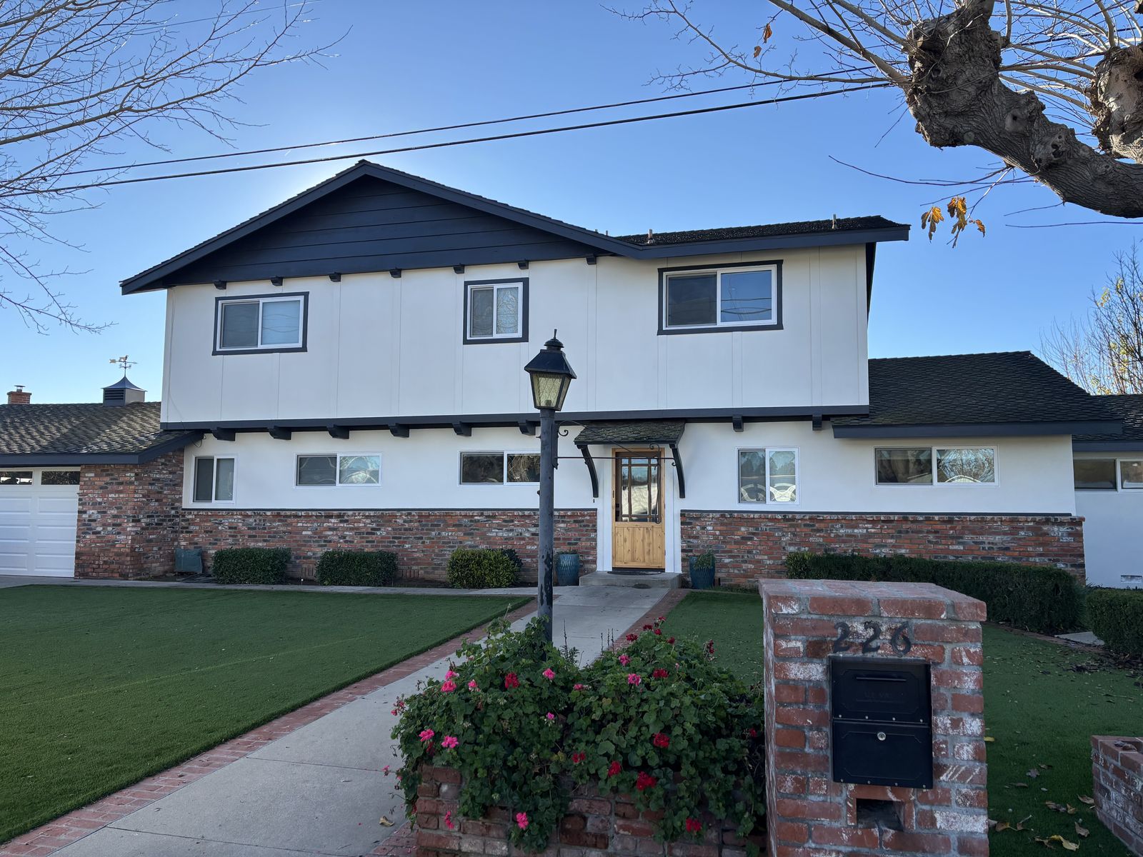 White two-story home exterior with dark charcoal trim in Santa Ynez, CA
